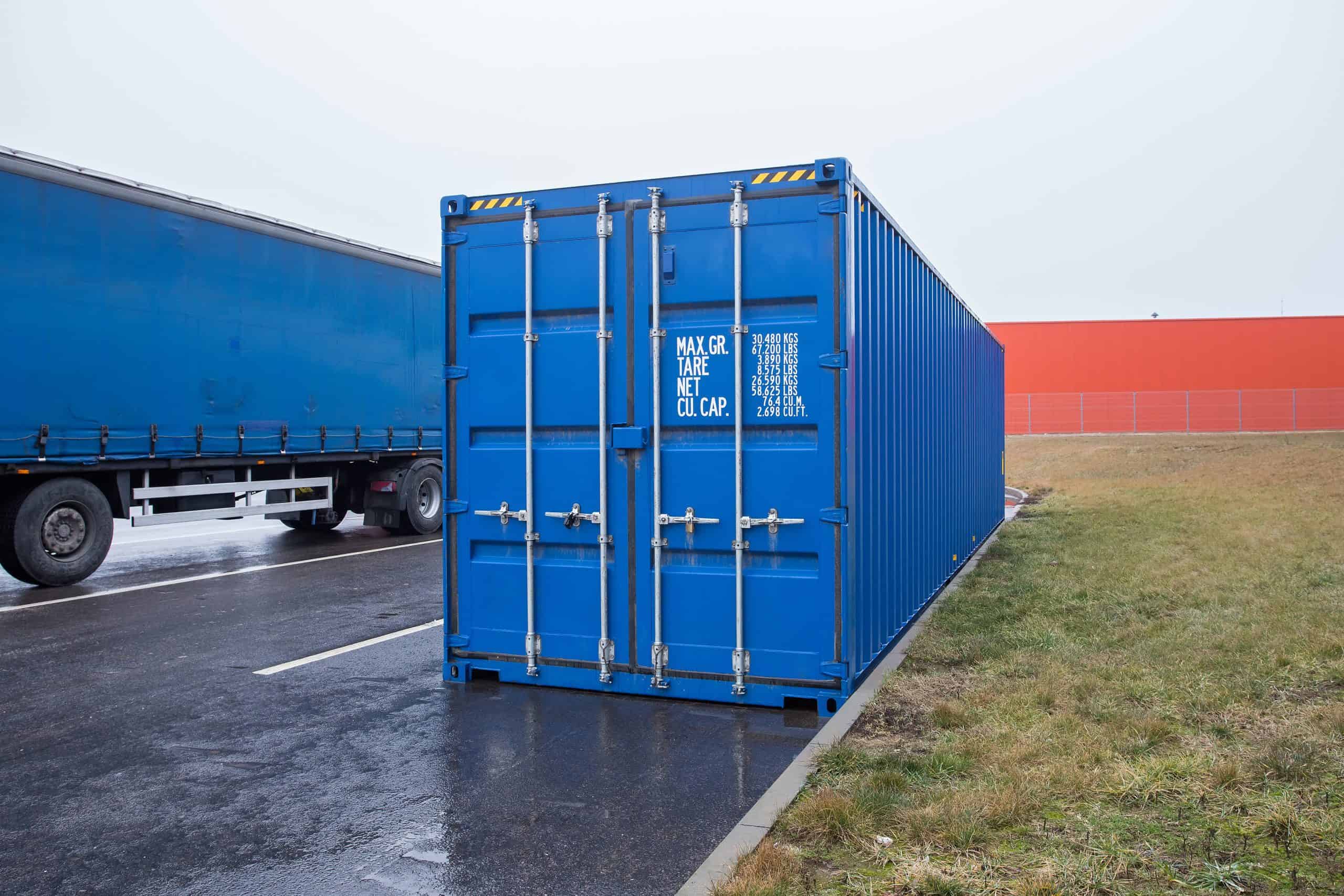 Blue,Transportation,Container,And,Truck,On,Parking
