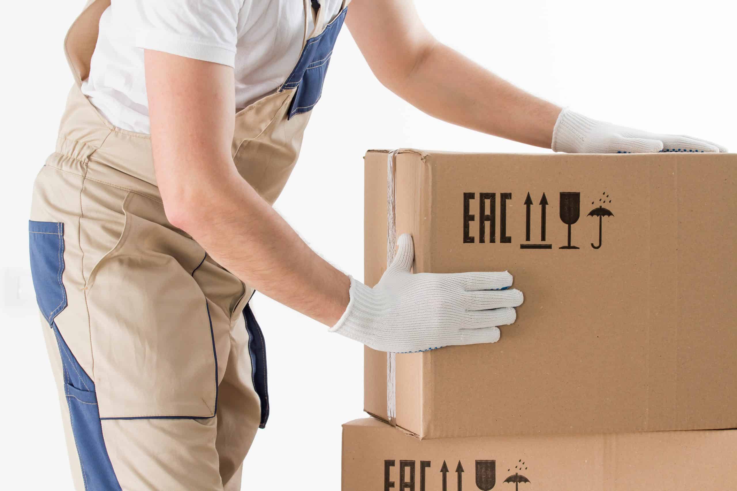 Relocation,Services,Concept.,Mover's,Hands,In,Uniform,Carrying,Cardboard,Box.